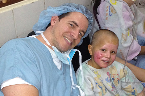 Dr. William T. Stoeckel of Wake Plastic Surgery with a young patient on a medical mission in Bolivia